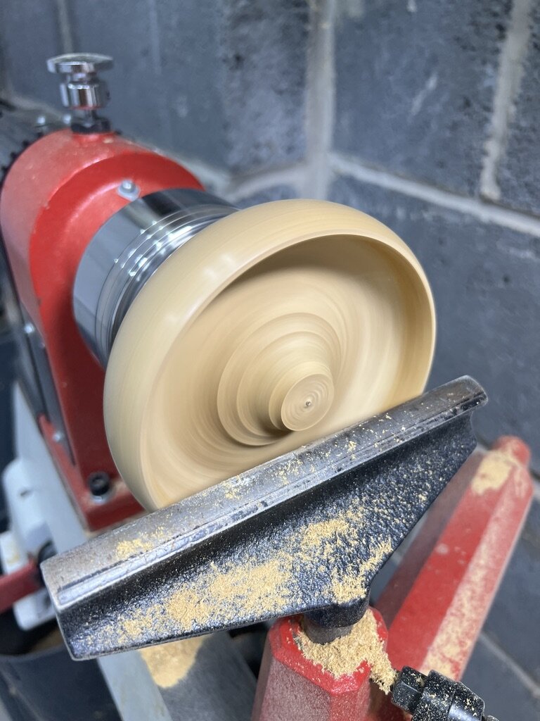 The middle of the bowl being hollowed on the lathe